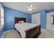 Bedroom featuring a wooden bed frame, ceiling fan, and a closet door, creating a cozy and inviting space at 5109 Makena Dr, Raleigh, NC 27615