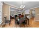 Open dining room area leading to living room with hardwood floors and ample light at 5109 Makena Dr, Raleigh, NC 27615