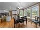 Well-lit dining room with hardwood floors, chandelier, and ample windows at 5109 Makena Dr, Raleigh, NC 27615