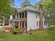 Charming two-story home featuring a brick and siding exterior, landscaped yard, and mature trees at 5109 Makena Dr, Raleigh, NC 27615