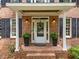 Inviting brick entryway with a white front door and decorative wreath at 5109 Makena Dr, Raleigh, NC 27615