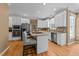 Kitchen featuring white cabinets, stainless appliances, island with barstool seating at 5109 Makena Dr, Raleigh, NC 27615