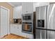 Kitchen with white cabinetry, stainless appliances and granite countertops at 5109 Makena Dr, Raleigh, NC 27615