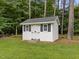 A shed sits amongst mature trees in the backyard providing extra storage at 5109 Makena Dr, Raleigh, NC 27615