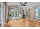 Bright sunroom with hardwood floors and a wall of windows overlooking the backyard at 5109 Makena Dr, Raleigh, NC 27615