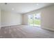 Finished basement with neutral carpet, recessed lighting, and a sliding glass door leading to the backyard at 5330 River Reach Dr, Raleigh, NC 27616