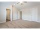 Carpeted bedroom with neutral walls and ceiling fan, with doors leading to a closet and bathroom at 5330 River Reach Dr, Raleigh, NC 27616