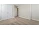Bright bedroom features neutral carpeting, base trim, large closet, and ample natural light at 5330 River Reach Dr, Raleigh, NC 27616