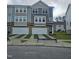 Modern townhome with a two-car garage, stone accents, and manicured lawn at 5330 River Reach Dr, Raleigh, NC 27616