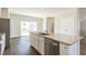 Kitchen featuring a large island with granite countertops, stainless steel appliances, and a sliding door at 5330 River Reach Dr, Raleigh, NC 27616