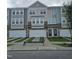View of newly constructed townhomes with multi-toned exterior and private driveways at 5334 River Reach Dr, Raleigh, NC 27616