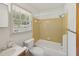 Cozy bathroom featuring a combined tub and shower, plus a window providing natural light at 555 Dacian Rd, Raleigh, NC 27610
