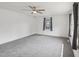 This bright, spacious bedroom features new carpeting, a ceiling fan, and two large windows at 555 Dacian Rd, Raleigh, NC 27610