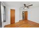 Hardwood floors and ceiling fan in a bedroom with closet and ensuite bathroom entrance at 555 Dacian Rd, Raleigh, NC 27610