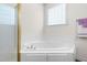 Bathroom with a separate glass-enclosed shower and a jacuzzi tub under a frosted glass window at 59 Carrousel Ct, Angier, NC 27501