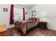 Cozy bedroom with a window, hardwood floors, and a wooden bed with colorful bedding at 59 Carrousel Ct, Angier, NC 27501