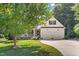 Charming two-story home with a two-car garage, front porch and mature trees at 59 Carrousel Ct, Angier, NC 27501