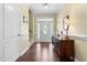Welcoming foyer with hardwood floors, elegant lighting, and a decorative front door at 59 Carrousel Ct, Angier, NC 27501