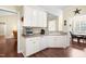Bright kitchen with white cabinetry, a breakfast bar, and access to adjacent living spaces at 59 Carrousel Ct, Angier, NC 27501