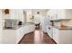 Functional kitchen with white cabinets, modern appliances, and a view into the dining area at 59 Carrousel Ct, Angier, NC 27501
