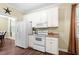 Clean kitchen featuring white appliances, ample cabinet space, and a view into the dining room at 59 Carrousel Ct, Angier, NC 27501