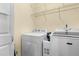 Clean laundry room with white washer and dryer, plus wire rack shelving for storage at 59 Carrousel Ct, Angier, NC 27501