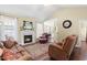 Cozy living room with a fireplace, comfortable seating, and view into the adjacent dining area at 59 Carrousel Ct, Angier, NC 27501