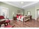 Bright main bedroom features hardwood floors, tray ceilings, and ample natural light at 59 Carrousel Ct, Angier, NC 27501