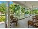 Inviting front porch with wicker furniture and hanging plants, perfect for relaxing outdoors at 59 Carrousel Ct, Angier, NC 27501