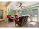 Bright sunroom featuring wicker furniture, a ceiling fan, and screened-in views of the outdoors at 59 Carrousel Ct, Angier, NC 27501