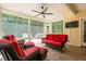 Enclosed sunroom features brightly colored furniture, tile flooring, and an airy atmosphere at 59 Carrousel Ct, Angier, NC 27501