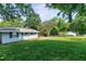 Lush backyard featuring mature trees, and a view of the home's exterior at 603 Nellane Dr, Garner, NC 27529