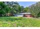 Exterior view of the home and backyard, lush with mature trees and well-maintained grass at 603 Nellane Dr, Garner, NC 27529