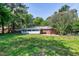 Backyard featuring lush grass, mature trees and patio at 603 Nellane Dr, Garner, NC 27529