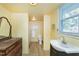 Bright bathroom with classic vanity, ceramic tile floors, and shower and tub combination at 603 Nellane Dr, Garner, NC 27529