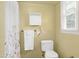 Bathroom featuring a classic white toilet, a towel rack, and a window with natural light at 603 Nellane Dr, Garner, NC 27529