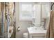 Bathroom with a clear glass sink, floral shower curtain and white vanity at 603 Nellane Dr, Garner, NC 27529
