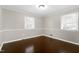 Bedroom features hardwood floors, neutral paint, and two windows at 603 Nellane Dr, Garner, NC 27529