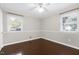 Well-lit bedroom featuring neutral walls, hardwood floors, and two windows at 603 Nellane Dr, Garner, NC 27529