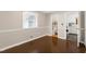 A bright bedroom features neutral walls and hardwood floors, seen with an attached bathroom at 603 Nellane Dr, Garner, NC 27529