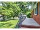 Inviting covered front porch of a brick home with green front lawn and trees at 603 Nellane Dr, Garner, NC 27529
