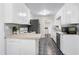 Well-lit kitchen with white cabinets, breakfast bar and dark flooring at 603 Nellane Dr, Garner, NC 27529