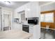 Traditional-style kitchen featuring white cabinets, a stainless steel microwave, and ample counter space at 603 Nellane Dr, Garner, NC 27529
