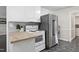 Kitchen featuring stainless refrigerator, white range oven, butcher block counter, and white cabinetry at 603 Nellane Dr, Garner, NC 27529