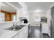 Charming eat-in kitchen featuring stainless appliances, white cabinets and a view of a sunlit dining area at 603 Nellane Dr, Garner, NC 27529