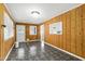 Classic living room featuring wood paneling, and abundant light pouring through the windows and door at 603 Nellane Dr, Garner, NC 27529