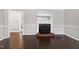 Bright living room with fireplace, neutral walls and glossy wood floors at 603 Nellane Dr, Garner, NC 27529