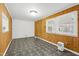 Light filled living room features two windows, classic wood paneling, and neutral wall paint at 603 Nellane Dr, Garner, NC 27529