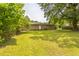 Spacious backyard featuring a well-maintained lawn and mature trees, perfect for outdoor activities at 605 Sexton Ave, Zebulon, NC 27597