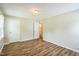 A bedroom featuring new wood floors, an open door to a bathroom and a closet at 605 Sexton Ave, Zebulon, NC 27597